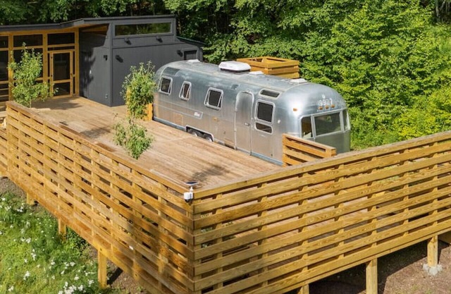 Sunlit Airstream in Trees with Expansive Deck + Nature Views