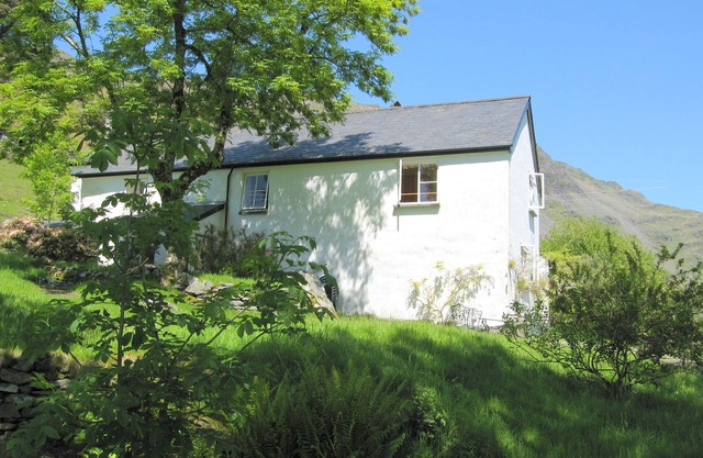 Traditional 18th century farmhouse on the slopes of a mountain
