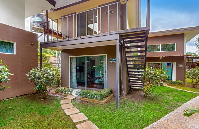 Tropical villas with pool access, scenic balcony, & shared full kitchen, dogs ok