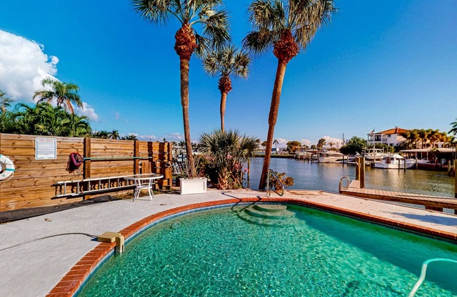 Two-story waterfront retreat with dock, pool, central AC, fireplace, & fast WiFi