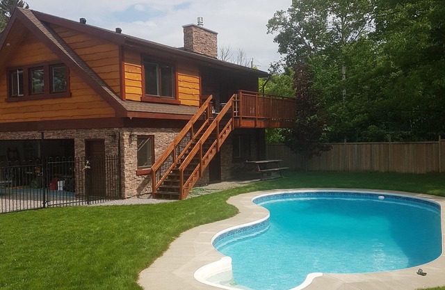 Rustic luxury chalet with pool, a two-minute walk to beach, park and playground!