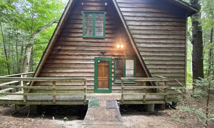 Allegan Casa | A-frame cabin nestled in forest, stunning lake view, perfect serenity.