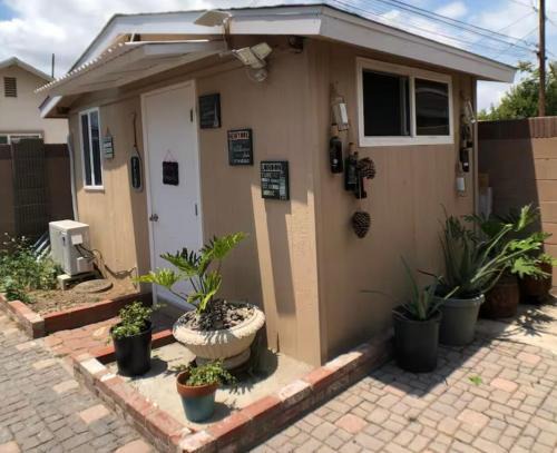 Norwalk Casa | A small room in the backyard with a full bed