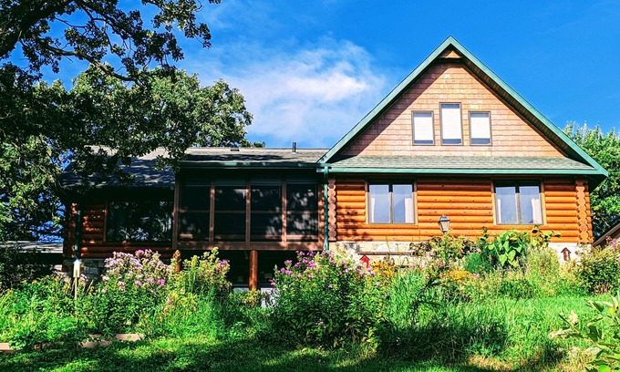 Albert Lea Casa | Happy Days Log Home and garden on Fountain Lake. Toys for all!
