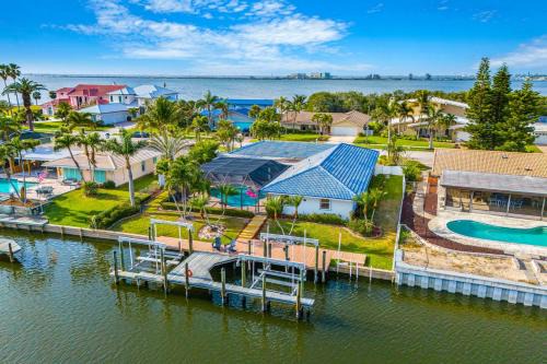 Cocoa Isles Villa | Casa De Olas - Waterfront Luxe Home - Heated Pool - Game Room - Boat Lift - Minutes to Beach