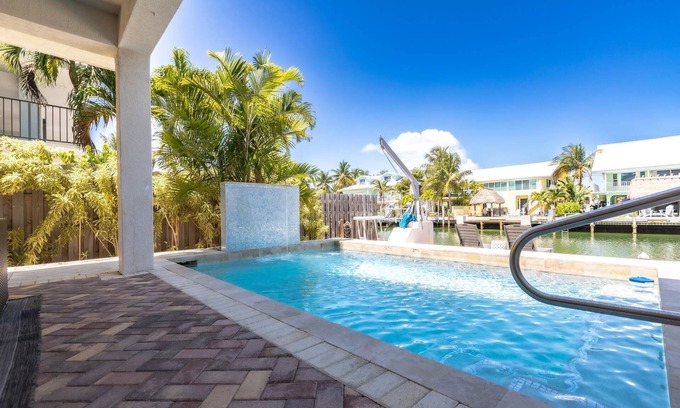 Coury Casa | Casa Paraiso: Discover This Charming 2BR Canal Front Duplex in KCB with Private Pool & Dockage!