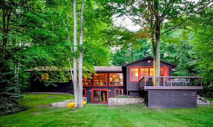 Lake Township Casa | Custom-designed lake house with screened porch, deck, Ping-Pong & lawn games