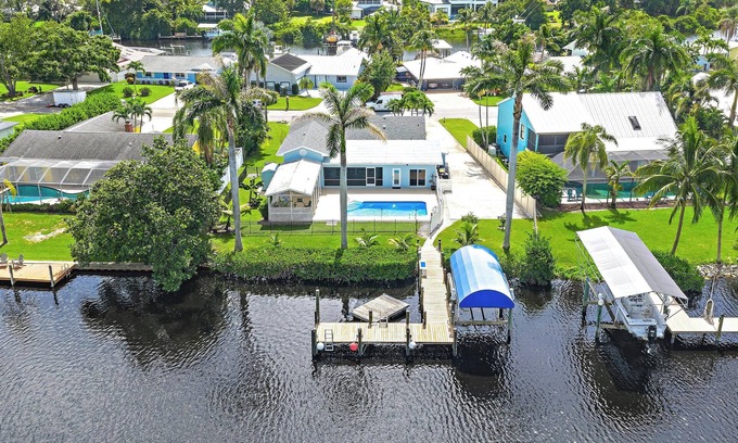 Palm City Casa | Deep water front home with private dock, pool, outdoor kitchen and pool table.