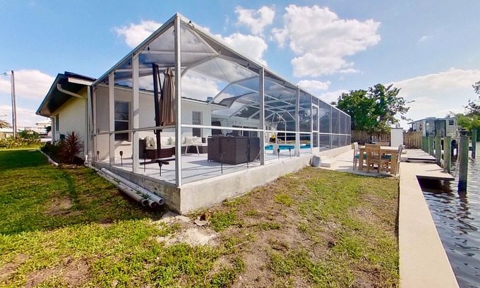 Fort Myers Casa | Dog-friendly home with private pool, dock, fireplace, patio, grill, & canal view