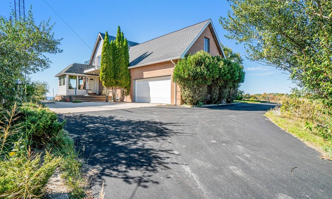 Arcadia Casa | Dog-friendly, lake view home with three season room, fireplace, video projector