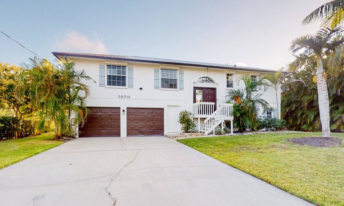 Redevelopment Area Casa | Dog-friendly waterfront home with extensive deck, canal views, lawn, W/D, AC