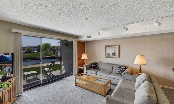 Charlevoix Condominio | Edgewater #119 | Water Views + Private Balcony | Pool, Hot Tub, Sauna | Patio