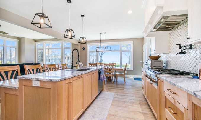 Riverside Casa | Enchanting lakefront home with pool, hot tub, firepit, game room, & washer/dryer
