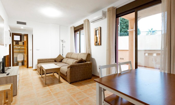 Los Geraeos Apartamento | Enjoy a relaxing vacation in this terraced house with communal pool.