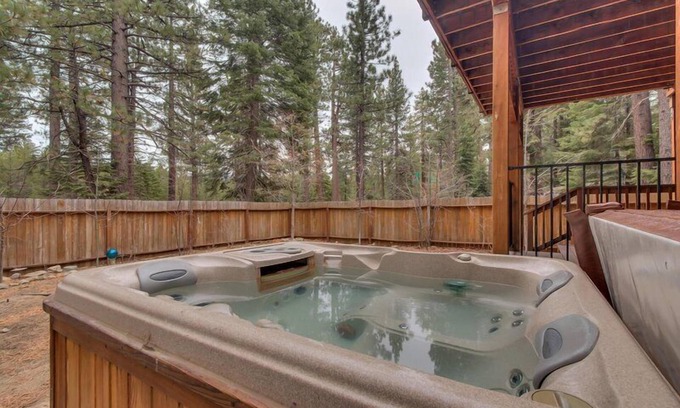 Tahoe Island Casa | Enjoy the tree-lined yard, spacious deck, and hot tub!