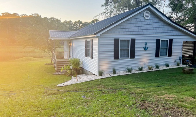 Shallotte Casa | Gorgeous creekside cottage with firepit, board games, dock, deck, & washer/dryer