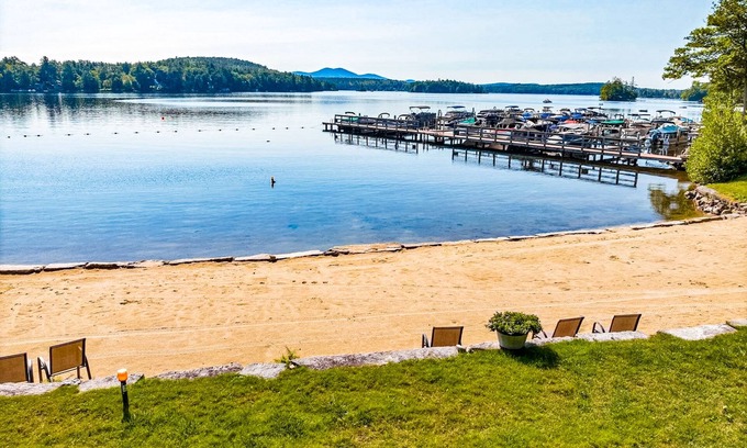 Meredith Casa | Idyllic lake retreat with beach access, firepit, wraparound porch, & great views