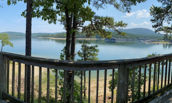 Mount Ida Cabaña | Lake view two bedroom, two bath loft, log-sided cottage with private hot tub overlooking Lake Ouachita. by RedAwning