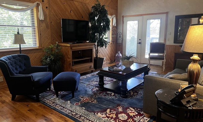 Mount Ida Cabaña | Lake view two bedroom, two bath loft, log-sided cottage with private hot tub overlooking Lake Ouachita. by RedAwning