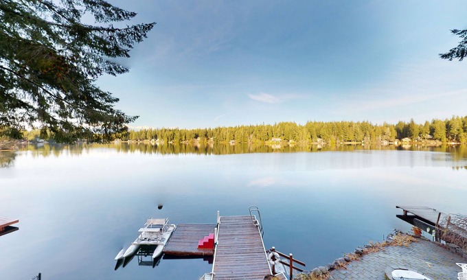 Mason County Casa | Lakefront studio-like home with beach access, lake views, wood stove, & firepit