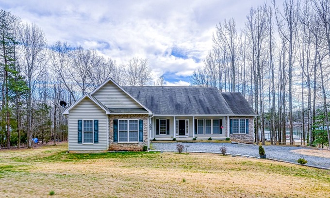 Bumpass Casa | Lakeside retreat with a dock, kayaks, firepit, hot tub, grill, game room, & deck