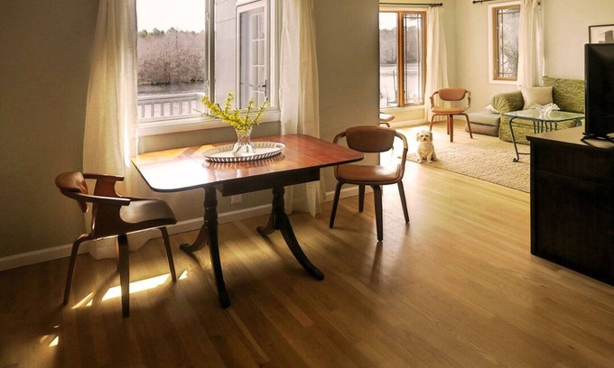Riverhead Casa | Light rippling on river, private dock, nature preserve beyond