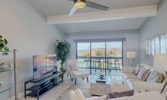 Capri Isle Condominio | Luxurious Coastal Condo with Waterway Views, Pool, Balcony, and Steps to Treasure Island Beach.