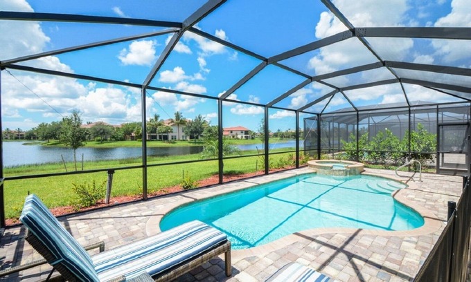 Naples Casa | Luxurious lakeview pool home in 5 Star Fiddler's Creek. Outdoor Dining & Kitchen