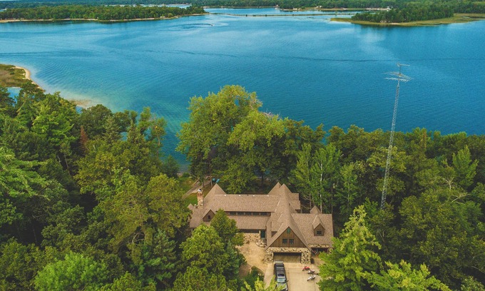 Nevis Casa | Luxury Lake Belle Taine retreat with private beach, sauna & four-season fun.