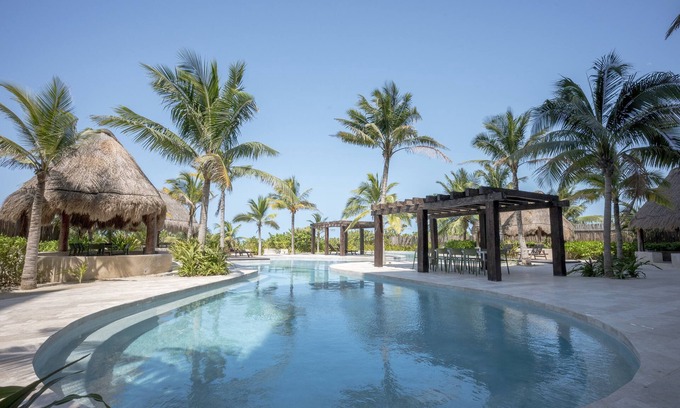 Ixil Apartamento | Oceanfront retreat with private balcony, outdoor pool, and stunning views