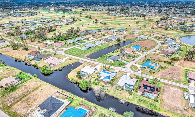 Pebble Beach Casa | Palm-lined waterfront retreat with enclosed pool, inviting patio, & central AC