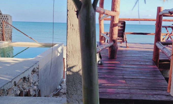 Chuburná Puerto Cabaña | Pasilla suite. Ocean view glass doors to the turquoise water, 13foot Tv screen