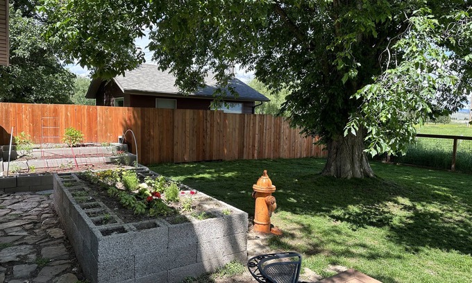 Ennis Casa | Pet friendly home with fenced yard, gardens and sauna one block from Main Street