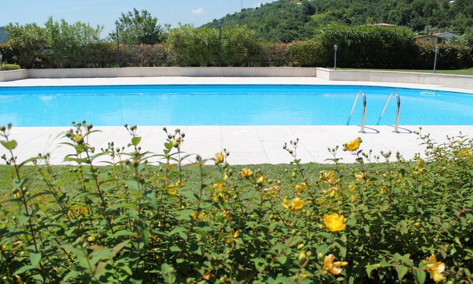 Villanuova sul Clisi Villa | Red villa with shared pool and private garden is the new black on Lake Garda