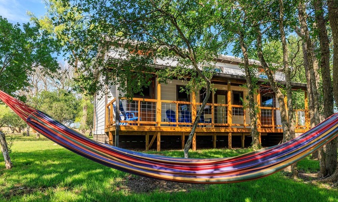 Fredericksburg Cabaña | River's Edge Cottage on waterfront with huge front porch & full river access