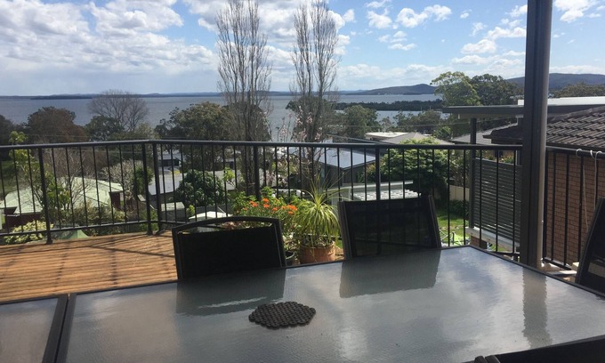 Soldiers Point Casa | Spacious covered balcony overlooking Sunset beach. Large garden and water views