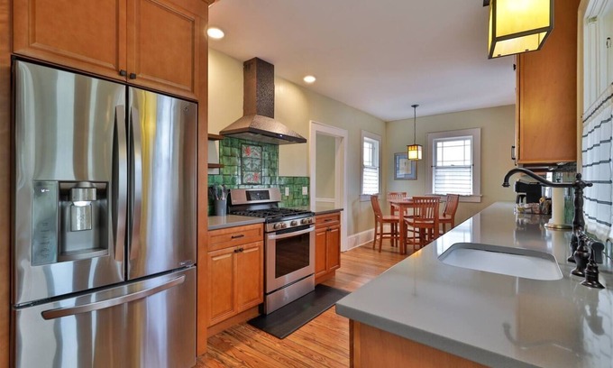Historic District Casa | Storybook home with wrap around porch and deck