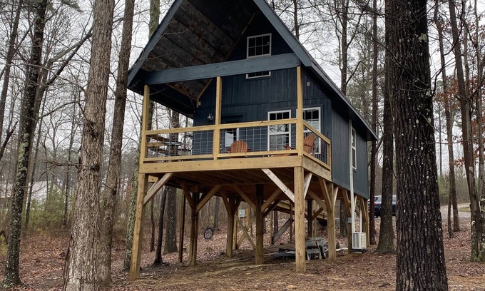 Mentone Cabaña | The Treehouses on wooded acreage that overlook a large lake.