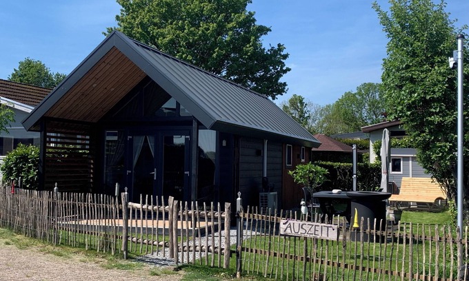 Lathum Casa | Tiny house time out at the lake and beach. Fenced garden, outdoor shower and fireplace.