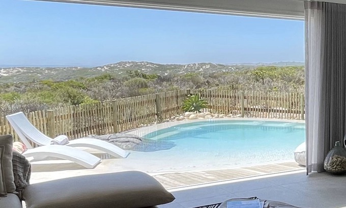 Grotto Bay Casa | Tranquil haven: home in nature's embrace, where ocean and dunes unite.