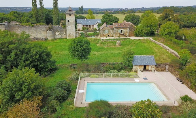 Ginals Casa | Two houses with a large swimming pool next to the ruins of a medieval castle