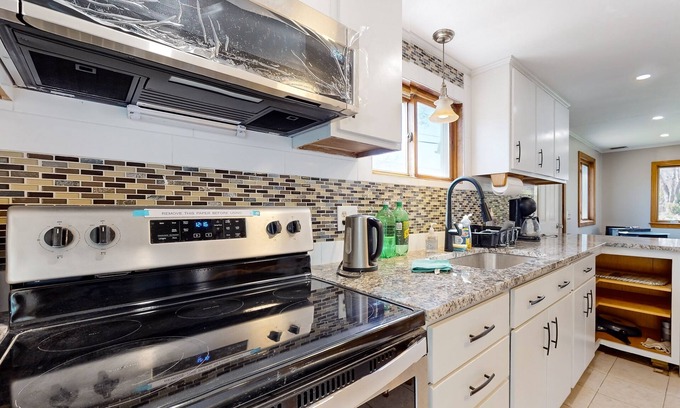 Sandown Casa | Two-story dog-friendly home with a lake view, deck, gas grill
