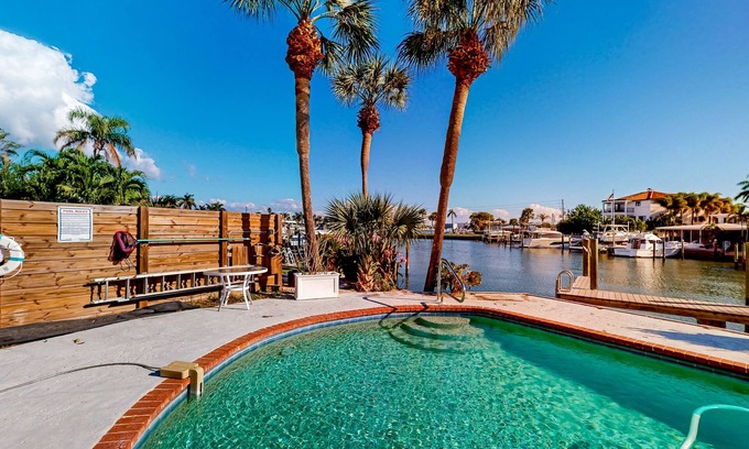 Capri Isle Casa | Two-story waterfront retreat with dock, pool, central AC, fireplace, & fast WiFi