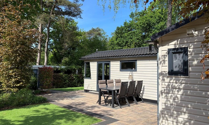 Lieren Casa | Veluwe Chalet featuring a charming veranda with a fire table.