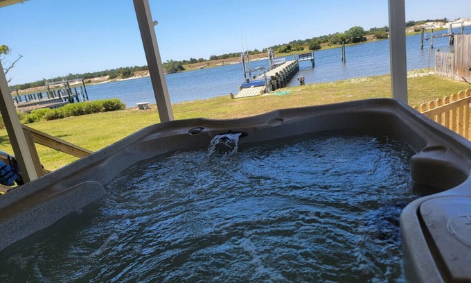 Cedar Point Casa | Waterfront home with Private Dock, 3 miles to Beach, Hot tub, kayaks, and swimming area, large fenced backyard, pet friendly