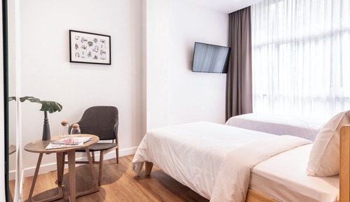 The Medium Twin Room with unlimited access to co-working space and 24/7 coffee and tea