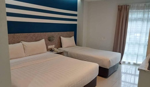 Habitación triple Deluxe, varias camas