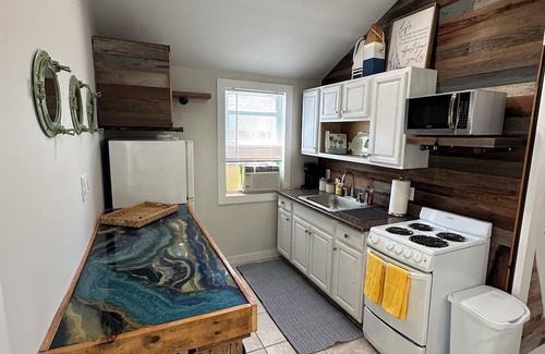 Patchogue Cabaña | A charming yellow cottage , where you can place your feet in the sand and relax!