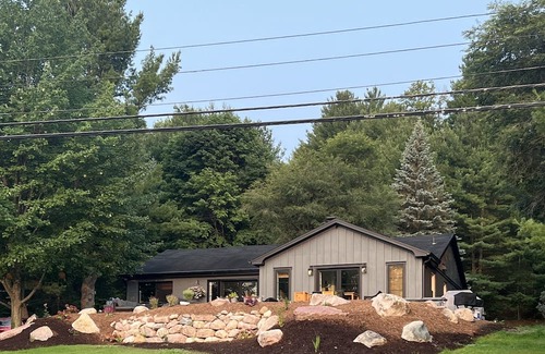 Rapid City Casa | 50 feet of Torch Lake frontage! Boathouse, beautiful patios sweet little beach.