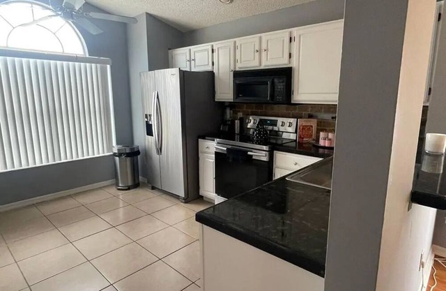 Spacious 4-bedroom house in delightful Davenport with WiFi, AC And Near Disney